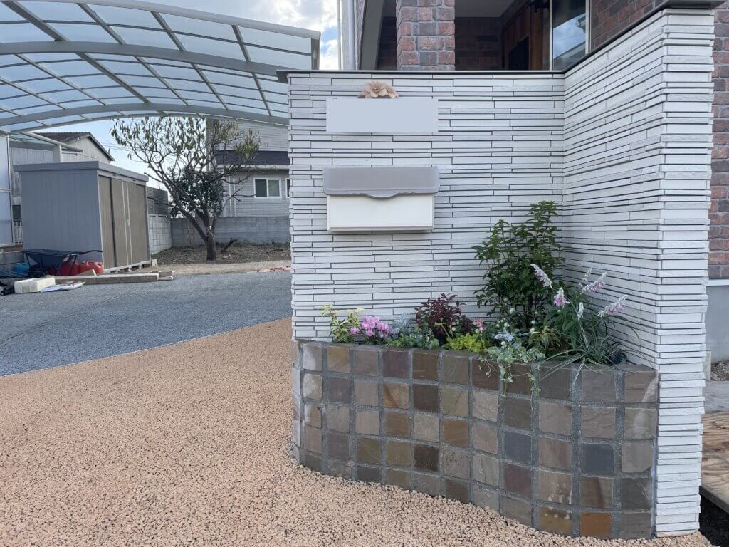 門柱と石材の花壇で植栽が彩るエクステリア